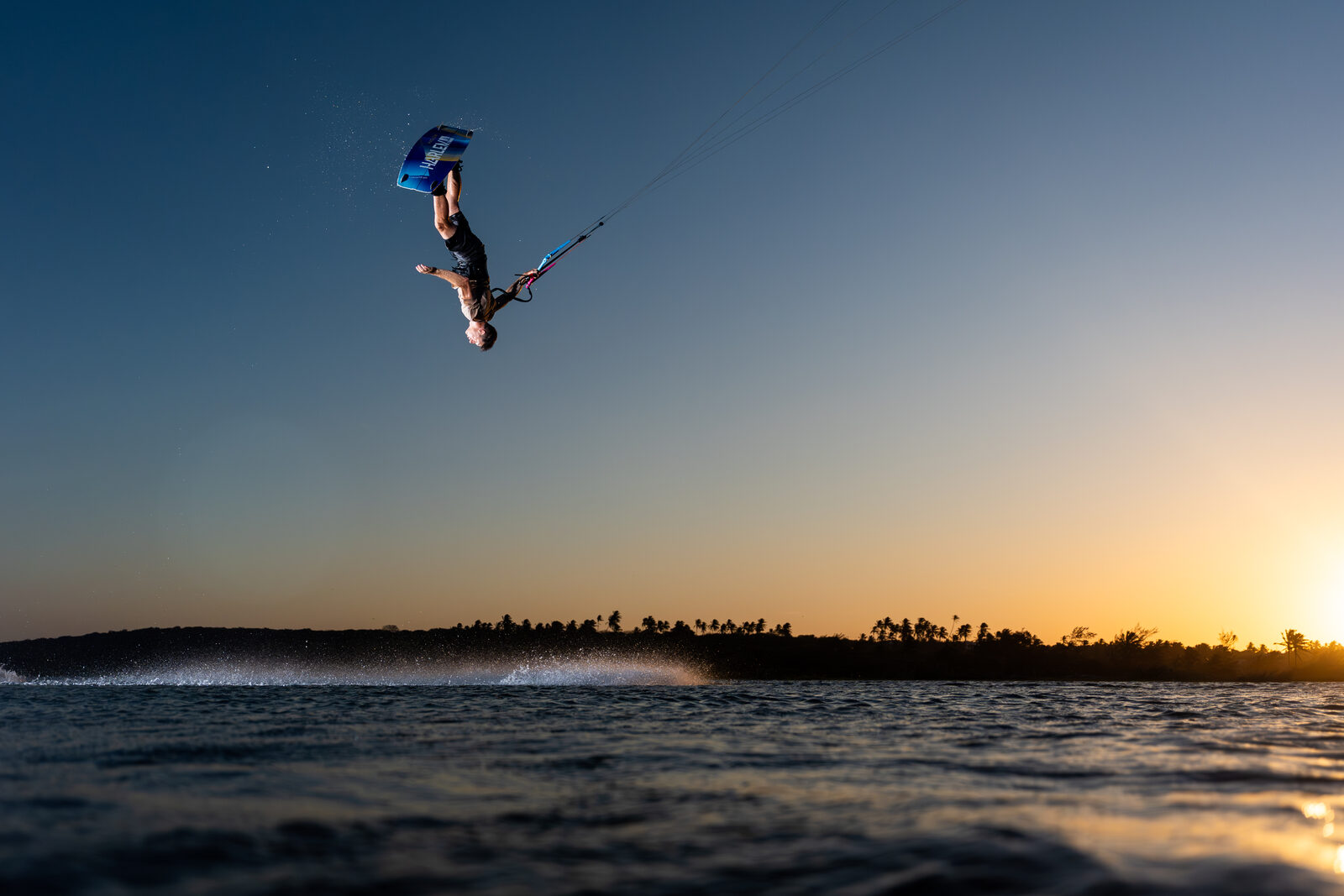 Aaron Hadlow carrying kite gear on the beach