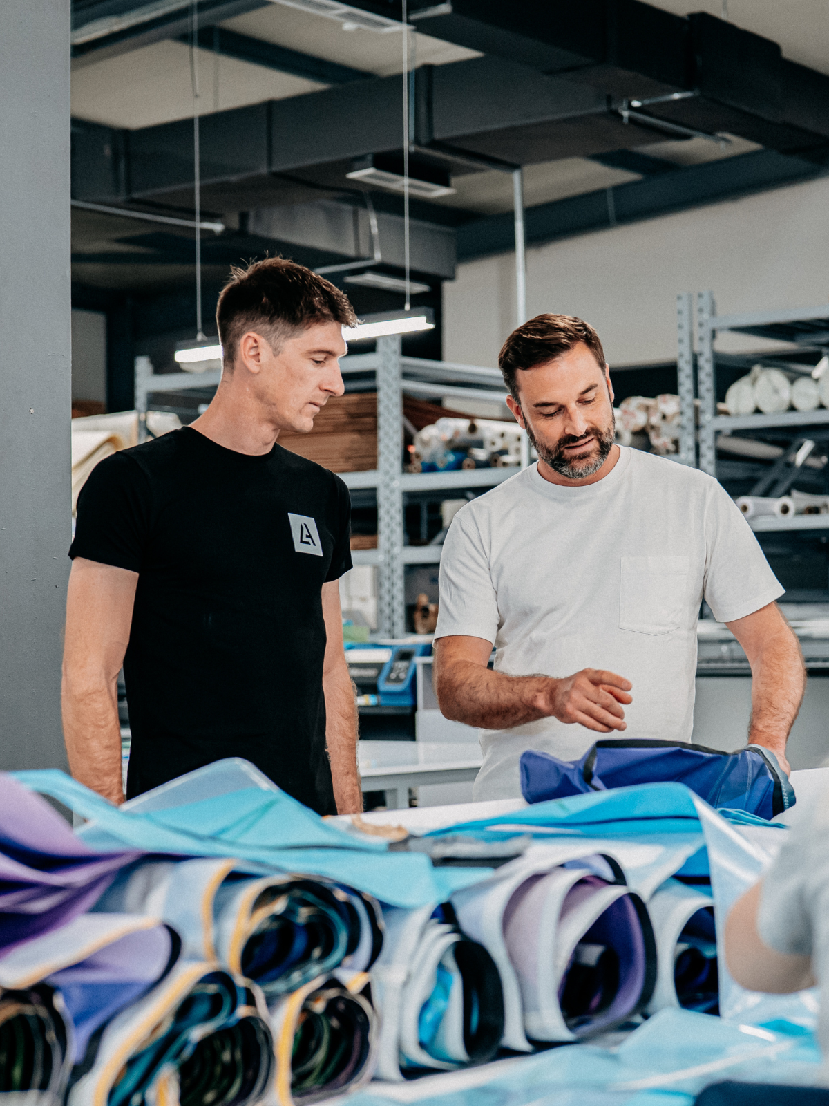 Aaron Hadlow reviewing kite materials with designer Ralf Groesel at Brainchild Production